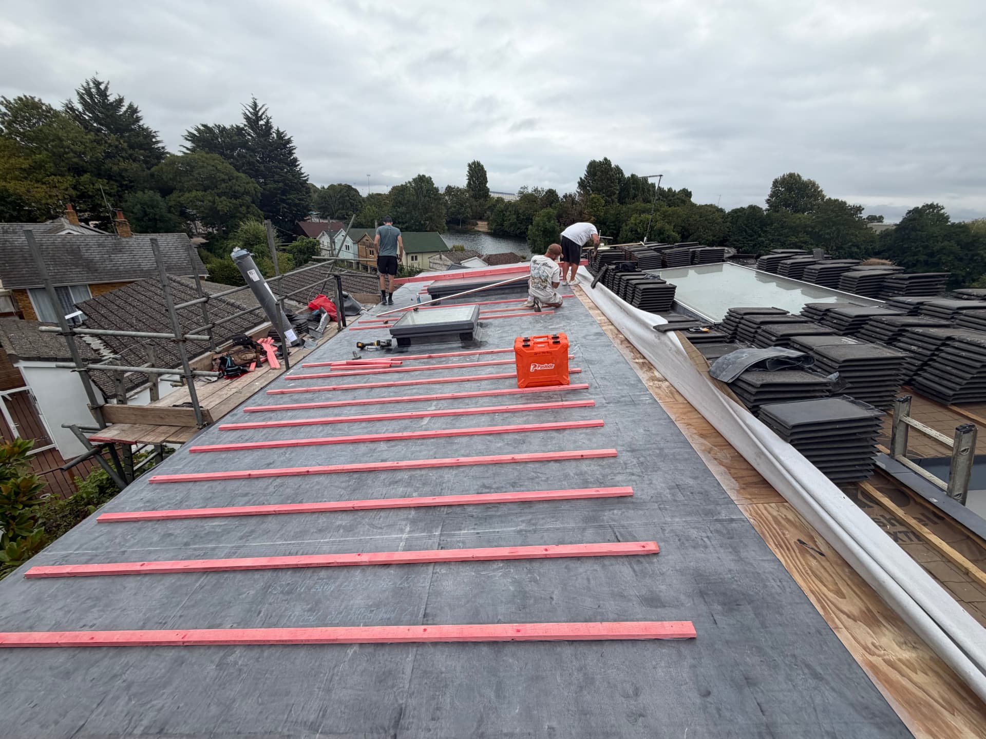 Original tiles stacked ready to be re-laid on the finished batten system