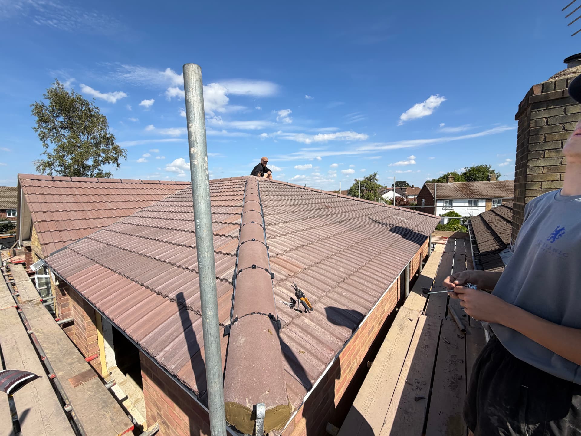 Completed Feltham re-roof — Redland 49 interlocking tiles with half-round dry ridge and hips