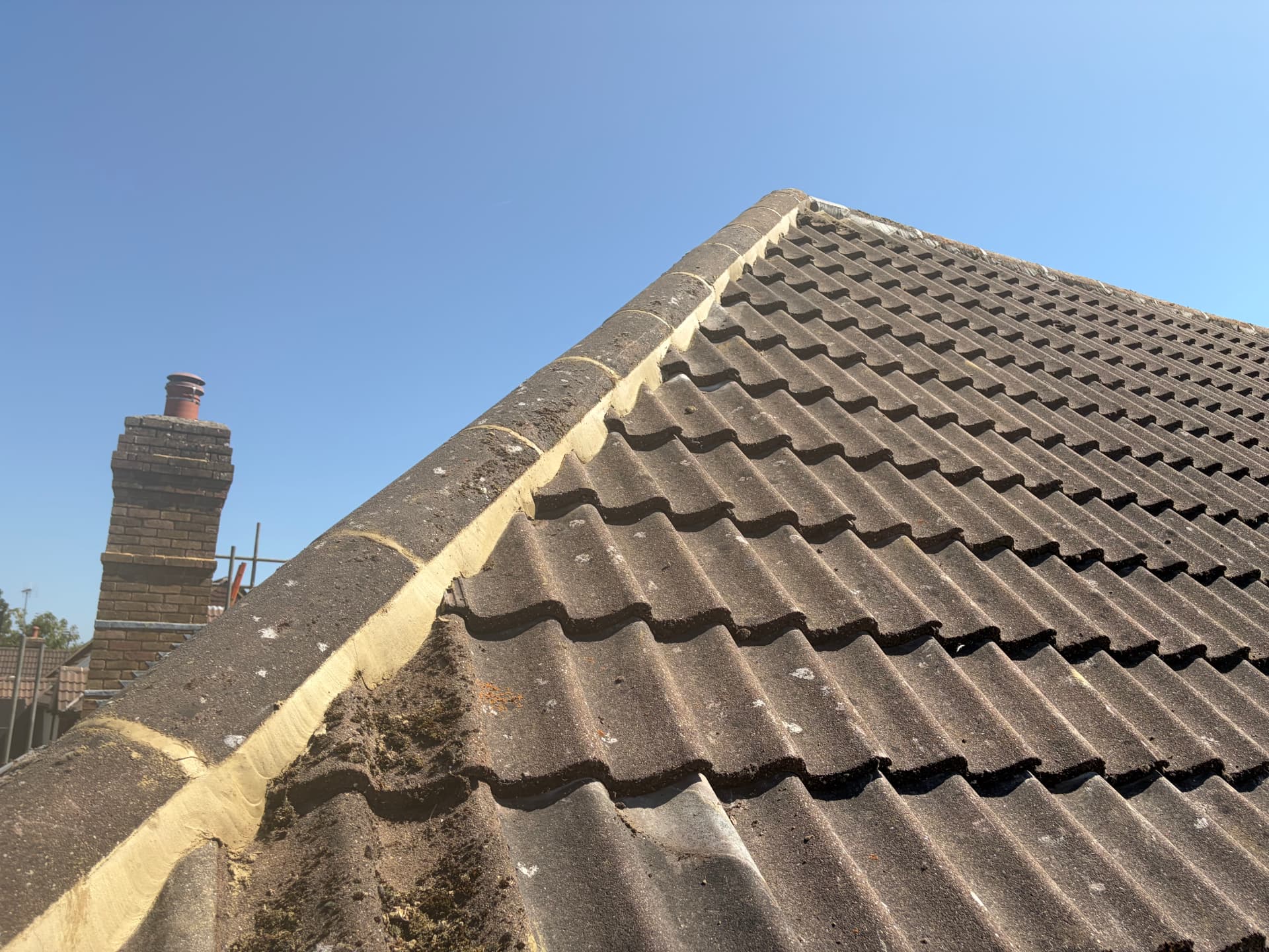 Fresh mortar rebedded along the ridge tiles of the Bracknell roof