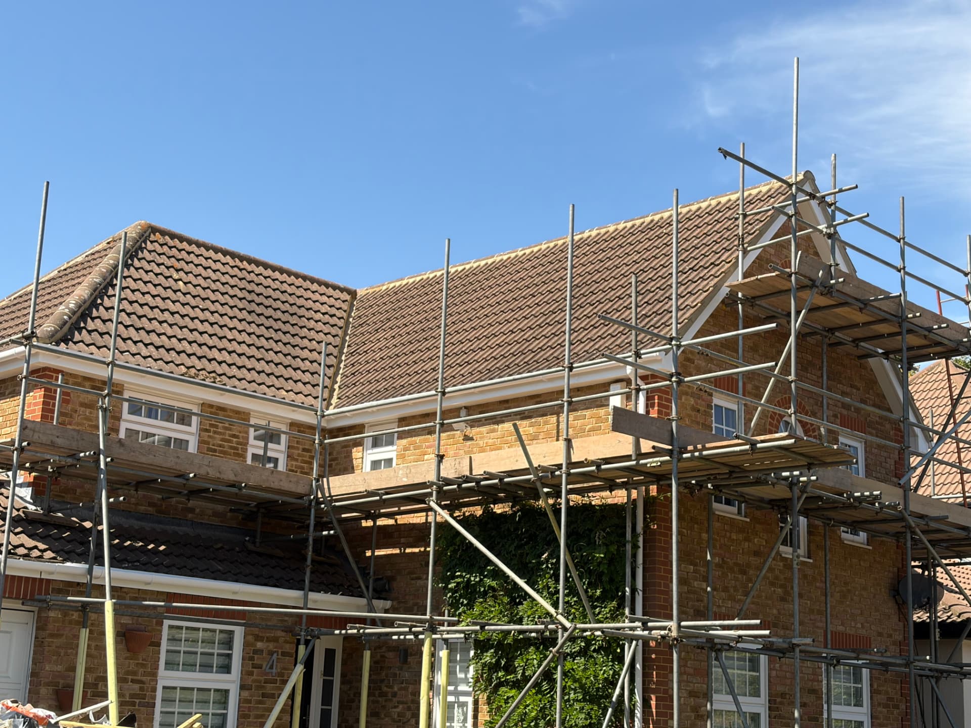 Front elevation of the Bracknell property under scaffold with renewed roofline and tiled roof
