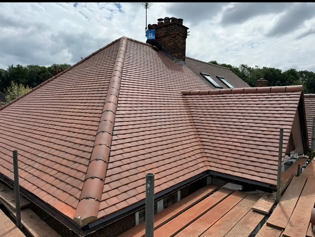 Artisanic Roofing craftsman installing a slate roof on a home in the South East of England